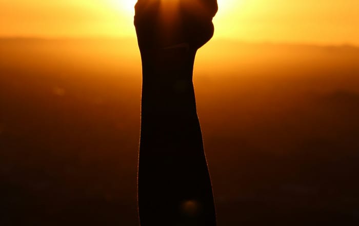 Picture of closed fist against a sunset